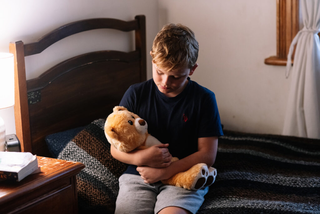 Child with emotional support bear